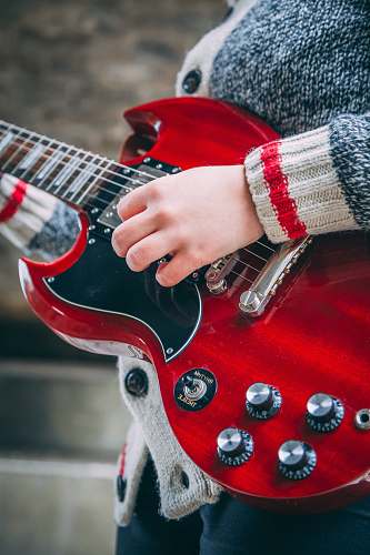 electric guitar person playing red SG guitar leisure activities